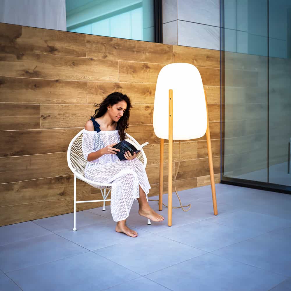 Illuminate your space with Rocket, a one-of-a-kind floor lamp by Newgarden, featuring wooden legs and adjustable lighting.